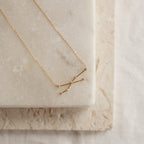 Constellation Necklace featuring a starry pendant, displayed on a marble slab with a neutral background—a celestial-inspired accessory for added charm.