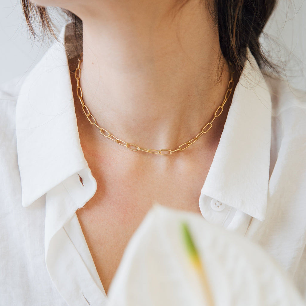 Wearing the Paperclip Toggle Necklace with a white collared shirt, she showcases effortless boho-chic style.