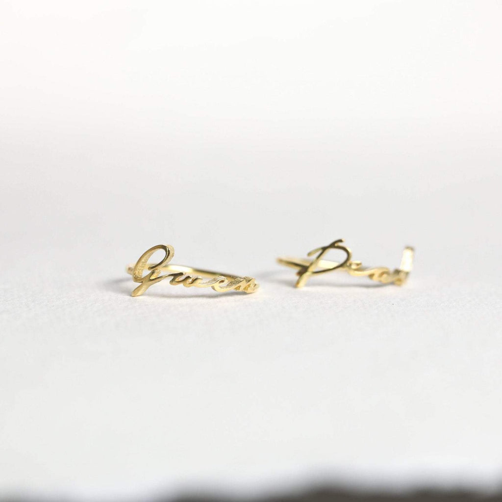 Two delicate Venice Name Rings in elegant cursive, shown on a light background—perfect custom jewelry pieces.