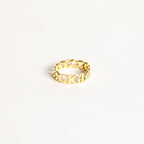 The Newsletter Curb Name Ring in Rose Gold features a gold chain design with personalized letters at the center, showcasing the classic curb name ring style against a plain white background.