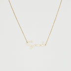 The Summer Name Necklace features a gold chain with a personalized pendant that spells "Sarah" in an elegant script font—perfect for any occasion.