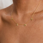 The Mama Letter Necklace displays "MAMA" in gold letter charms on your neck—a thoughtful gift to celebrate motherhood.