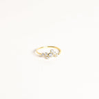 The Cluster Birthstone Ring features seven small round diamonds set in an asymmetric cluster on a white backdrop—ideal for those who appreciate classic design.