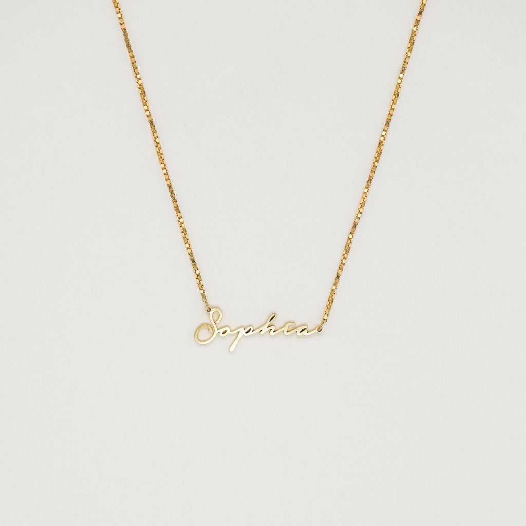 Venice Name Necklace in Box Chain featuring a dainty cursive pendant, displayed against a simple light background.