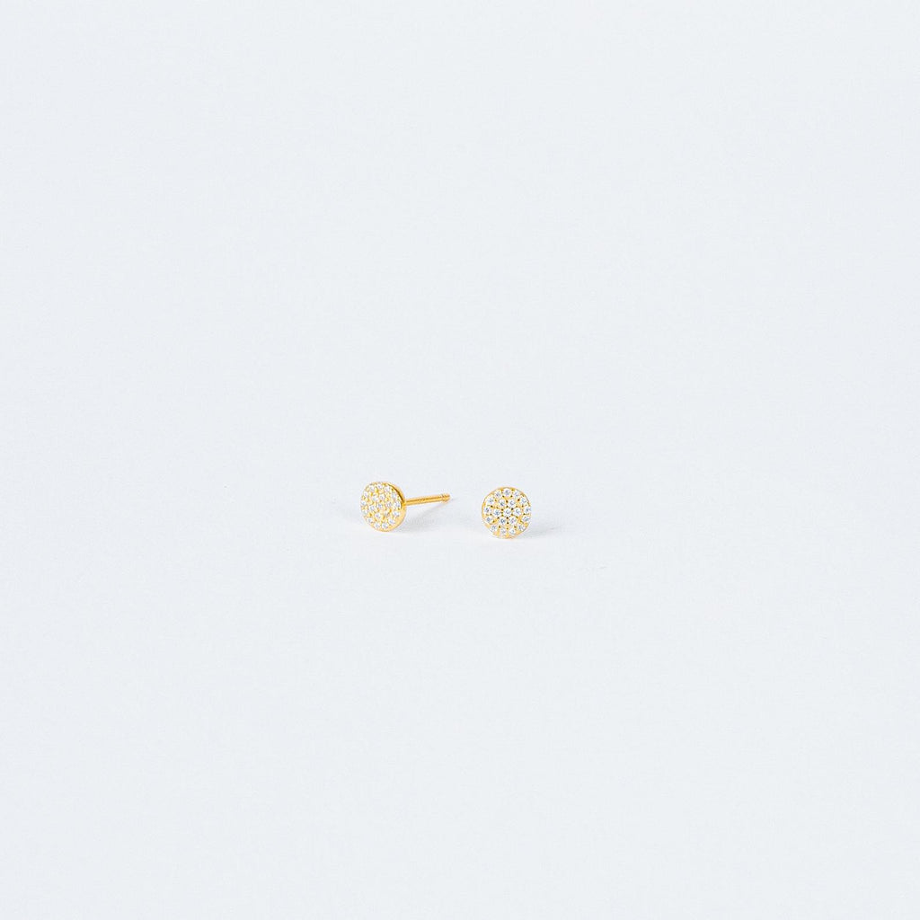Pave Round Studs feature small, round gold settings encrusted with sparkling crystals, adding a touch of glam to any look on a plain white background.