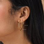 Close-up of an ear with straight dark hair, wearing Large Thin Hoops in 20mm and 30mm—an ideal simple hoop earring choice for everyday style.