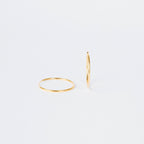Large Thin Hoops—one flat, one upright on a plain white background. These simple earrings offer versatile, timeless style, making them an effortless addition to any everyday wardrobe.