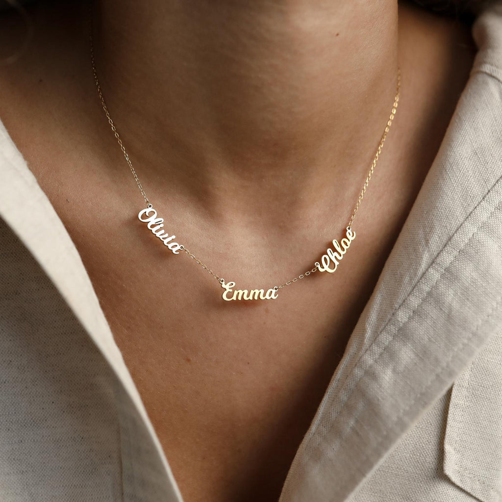 The Mellow Multiple Name Necklace in gold, personalized with names like Olivia, Emma, and Chloe, makes a perfect jewelry gift for mom to wear around her neck.
