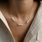 The Mellow Multiple Name Necklace in gold, personalized with names like Olivia, Emma, and Chloe, makes a perfect jewelry gift for mom to wear around her neck.