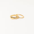 Two interlocking gold rings from the Duo Form Ring Set displayed on a clean white background.