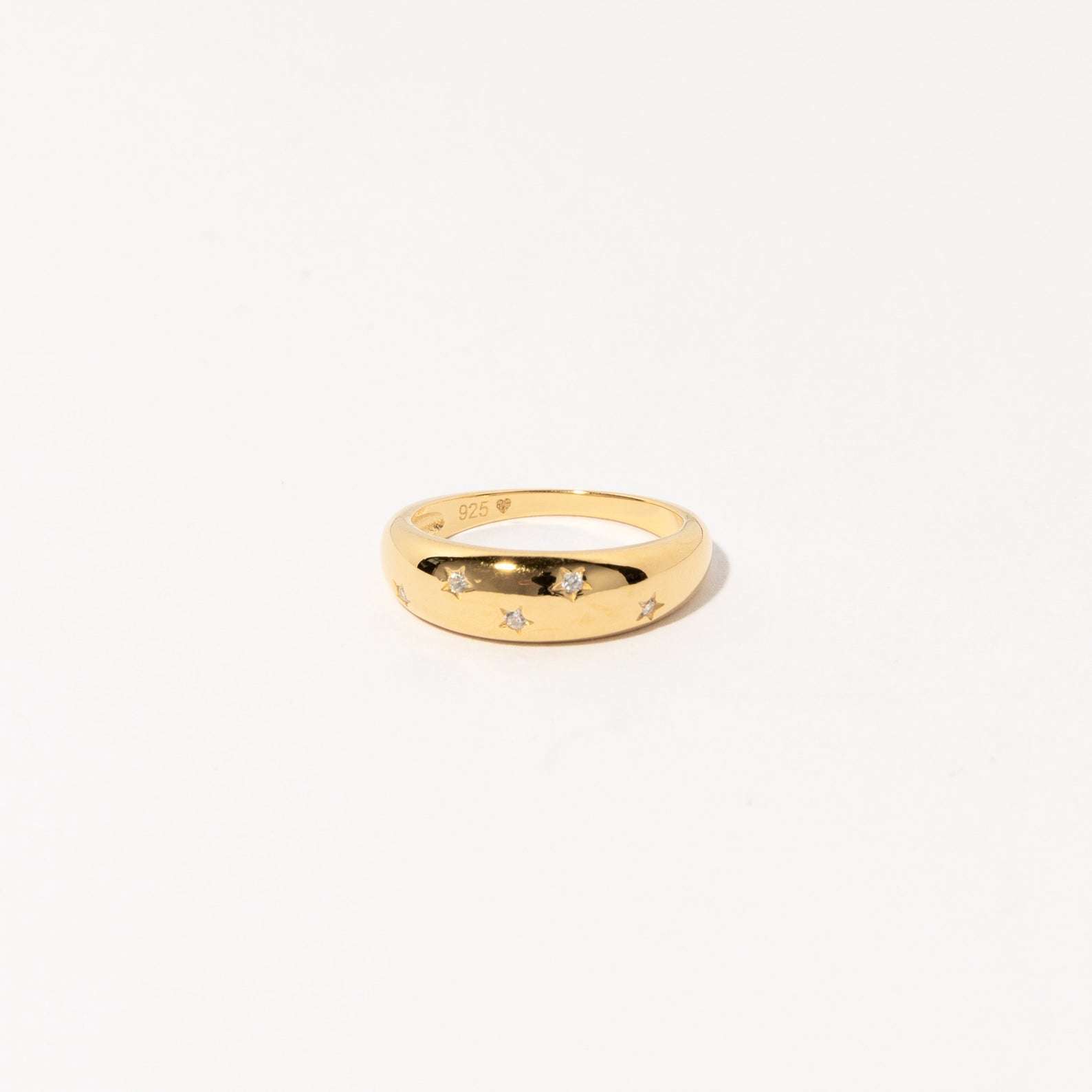 The Star Dome Ring showcases star-shaped engravings and diamond-encrusted stones, making it an eye-catching choice for a bold ring stack, beautifully presented against a plain white background.