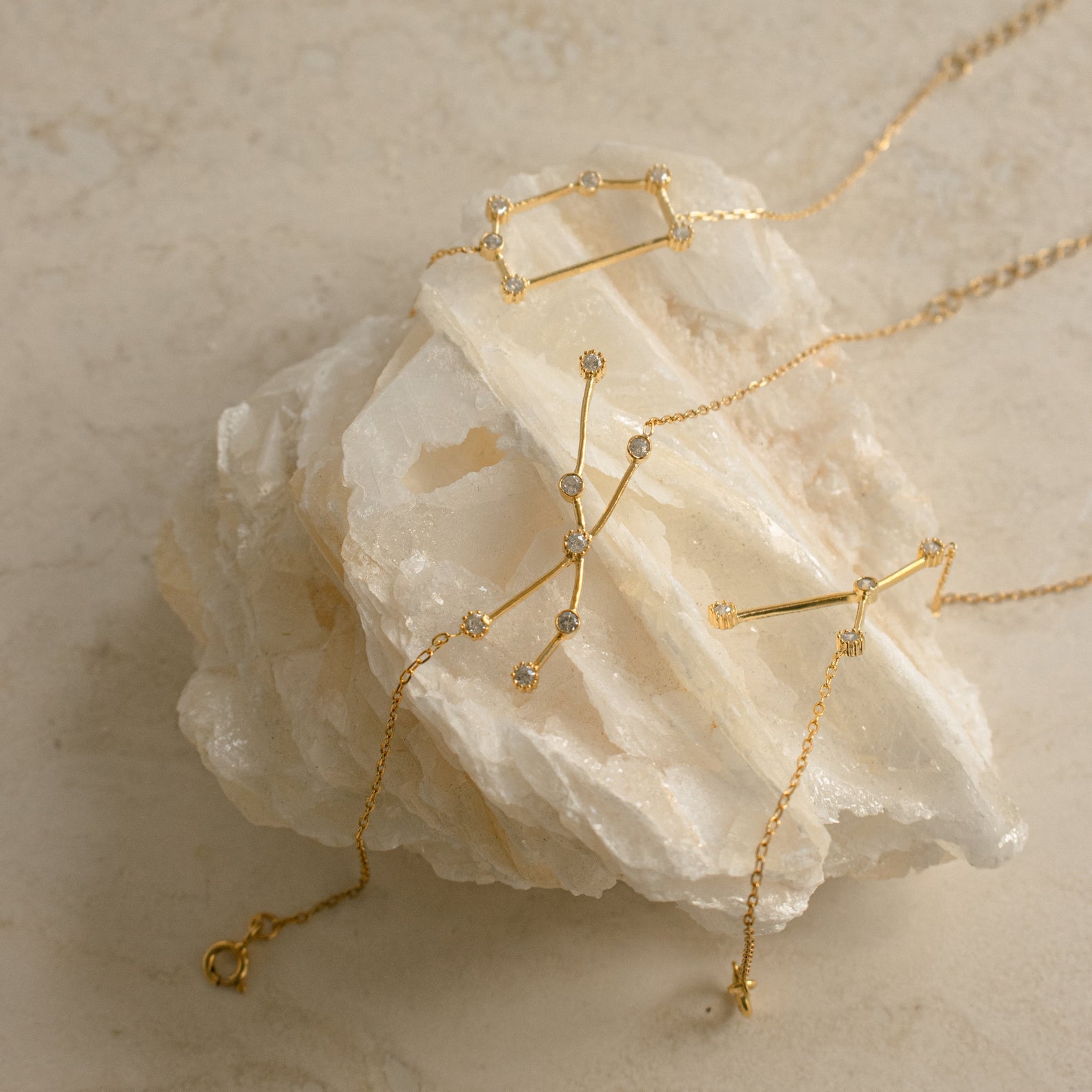 The Constellation Bracelet features a minimal, geometric design displayed on white crystal stone—ideal for those who love unique and modern jewelry styles.