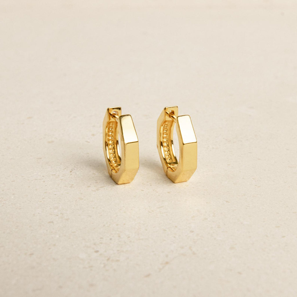 The Audrey Huggies are a stylish pair of gold earrings, perfect for everyday wear.