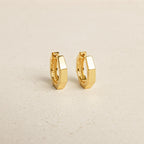 The Audrey Huggies are a stylish pair of gold earrings, perfect for everyday wear.