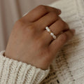 A hand adorned with the Pearl Beaded Ring, crafted with lustrous freshwater pearls—an elegant and timeless accessory.
