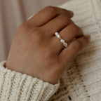 A hand adorned with the Pearl Beaded Ring, crafted with lustrous freshwater pearls—an elegant and timeless accessory.