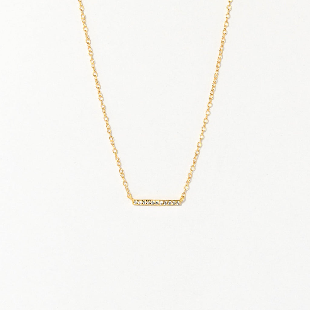 The Pave Bar Necklace features a gold chain with a petite, sparkling bar pendant—ideal for adding subtle shine to your look or layering with other necklaces.