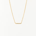 The Pave Bar Necklace features a gold chain with a petite, sparkling bar pendant—ideal for adding subtle shine to your look or layering with other necklaces.