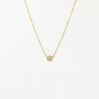 The Pave Round Necklace features a gold chain with a small, pavé-encrusted circle pendant, shown on a plain white background.