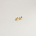 The Hailey Ball Studs are small gold earrings with screw-on backings, ideal for starter earrings, displayed against a plain white background.