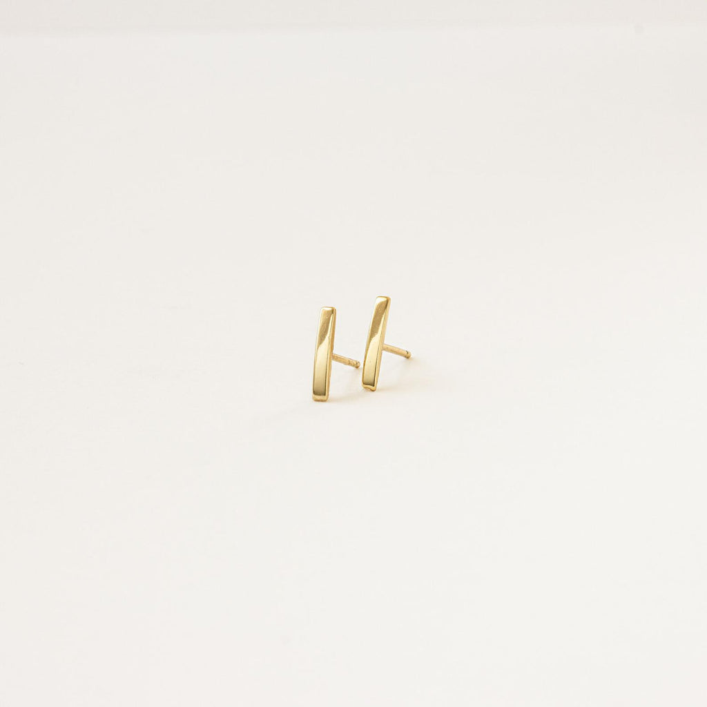 Dainty Bar Studs: these minimalist earrings are perfect for an effortless earring stack, shown on a plain light background.