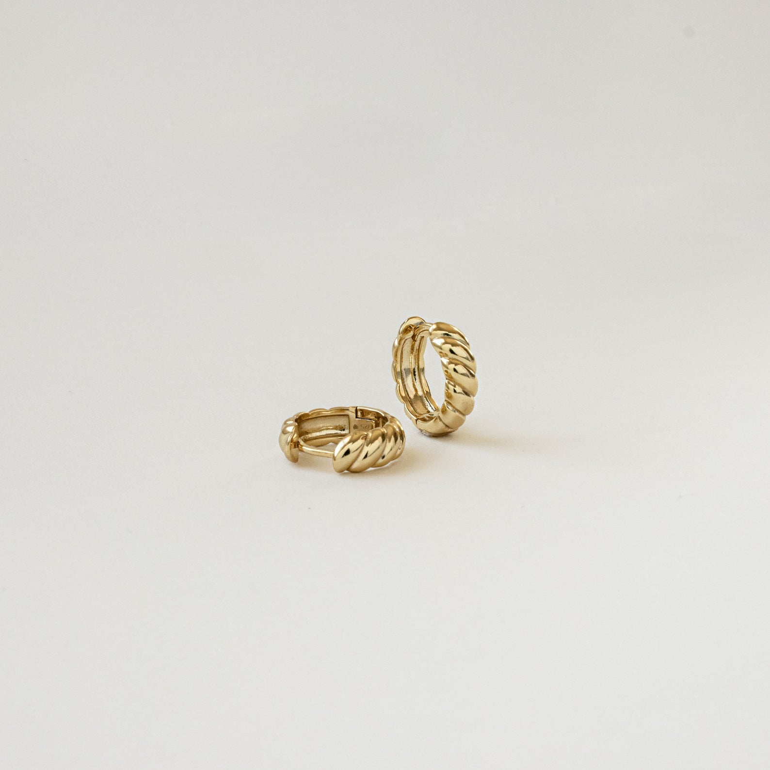 The Morgan Croissant Hoops are gold earrings that add a chic French girl aesthetic to any modern accessories collection.