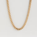 Isolated shot of the gold curb chain necklace against a white background.