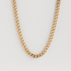 Isolated shot of the gold curb chain necklace against a white background.