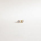 The Round Diamond Studs are classic gold stud earrings featuring round clear gemstones, evoking timeless elegance, displayed on a plain white background.