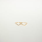 The Curve Stacking Set features two delicate gold rings with open triangle designs, one accented by small gemstones, offering a modern touch to your favorite ring stack.