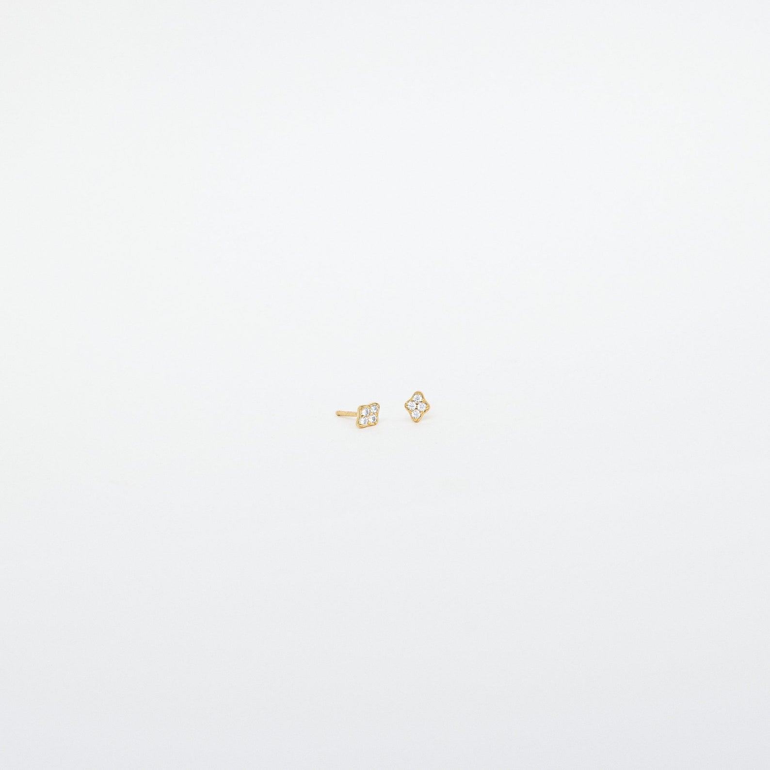 Avery Geometric Diamond Studs: Small gold diamond-shaped studs with tiny clear pavé stones, shown against a plain white background.