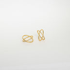 The Pave X Ring showcases two gold crossover bands, one adorned with pavé-set tiny diamonds, set against a plain white background.