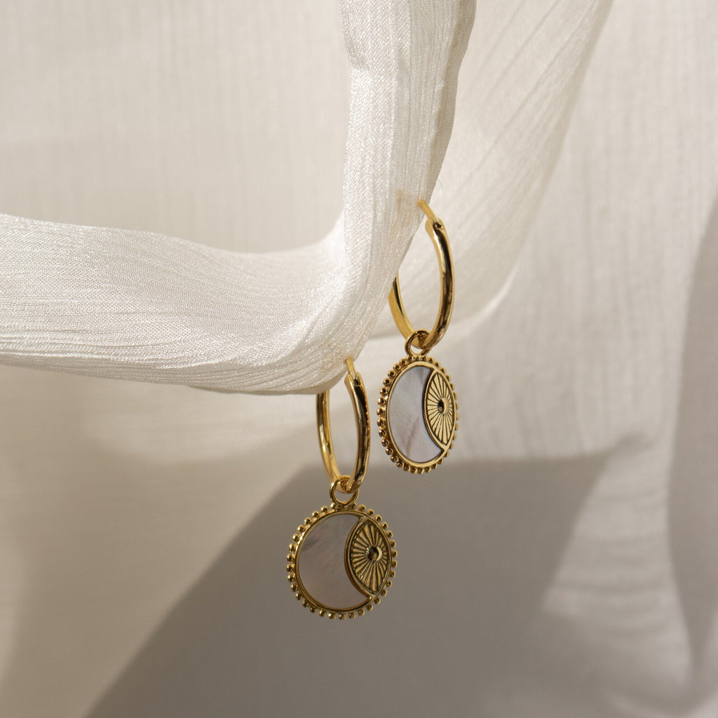 The Pia Pearl Coin Hoops are gold boho earrings with delicate coin pendants, perfect for adding a charming touch to any outfit.