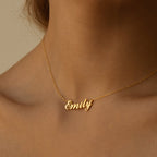 The Carrie Name Necklace, worn on bare skin, showcases timeless elegance with its custom name pendant design.