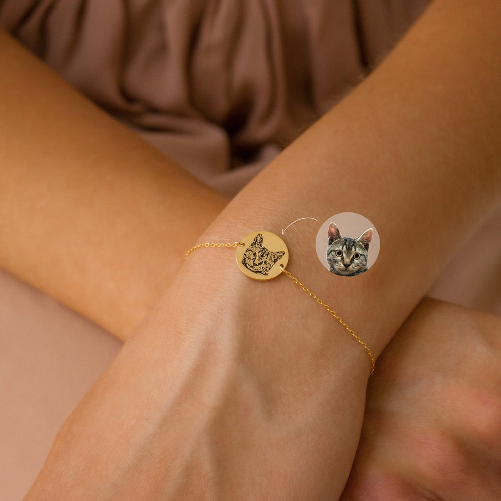 The Pet Portrait Disc Bracelet features a gold charm engraved with your cat's face, making it unique pet jewelry—perfect as a memorial gift or everyday keepsake.