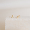 Glacier Diamond Studs showcased on a textured white stone surface with a neutral background.