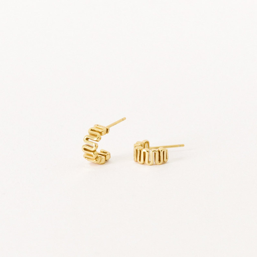 The Maze Half Hoops are modern gold earrings with a geometric design, ideal for a unique earring stack and shown against a white background.