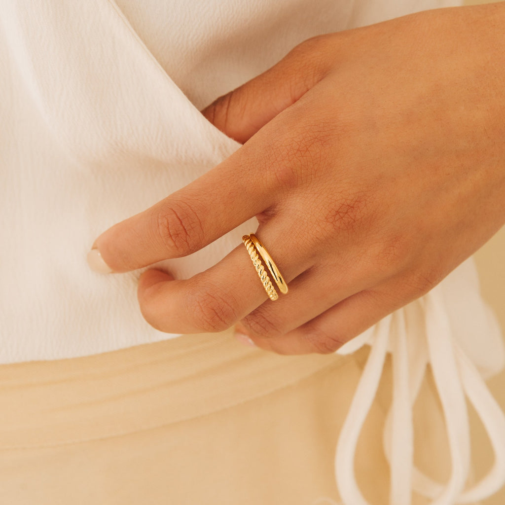 Chelsea Duo Ring in gold worn on hand against cream outfit, highlighting its bold polished look.