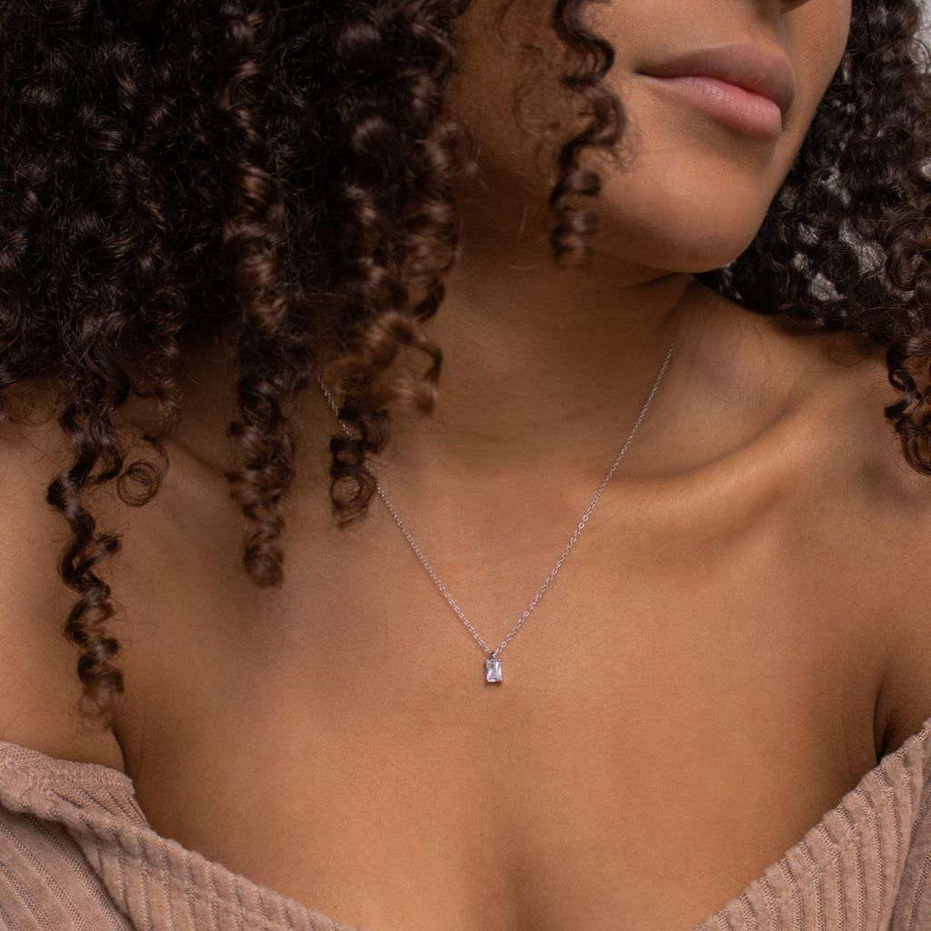 Wearing the Sage Diamond Necklace, a woman radiates timeless elegance and highlights the beauty of this luxury piece.