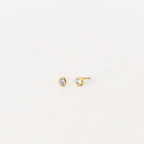 Jane Diamond Studs: small gold earrings with round brilliant diamonds, bezel set for a timeless look, displayed on a plain white background.