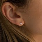 A close-up of a woman’s ear wearing Booker Classic Diamond Studs, highlighting the timeless elegance and everyday versatility of these classic diamond earrings.