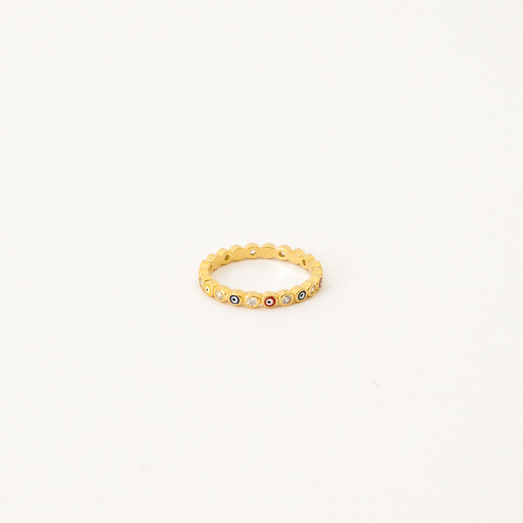 The Rainbow Evil Eye Ring features multicolored gemstones set around the band, bringing a vibrant twist to classic evil eye jewelry. Displayed on a white background, this lucky charm ring adds bold protection to any style.