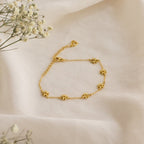 The Flower Child Bracelet features delicate gold star charms on soft cream fabric with small white flowers—a whimsical accessory for your cottage-core style.