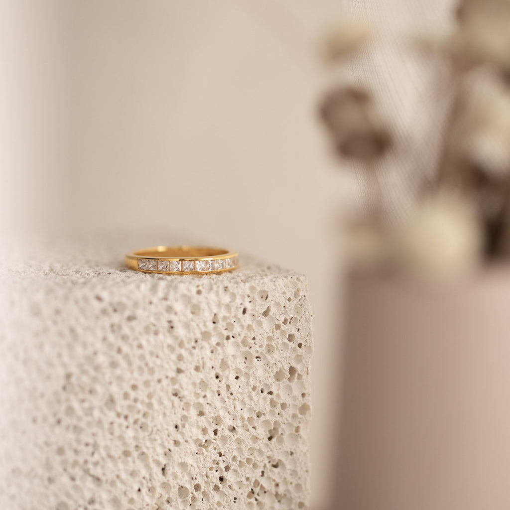 Evermore Diamond Band in 18K gold with pave-set diamonds on textured neutral background.