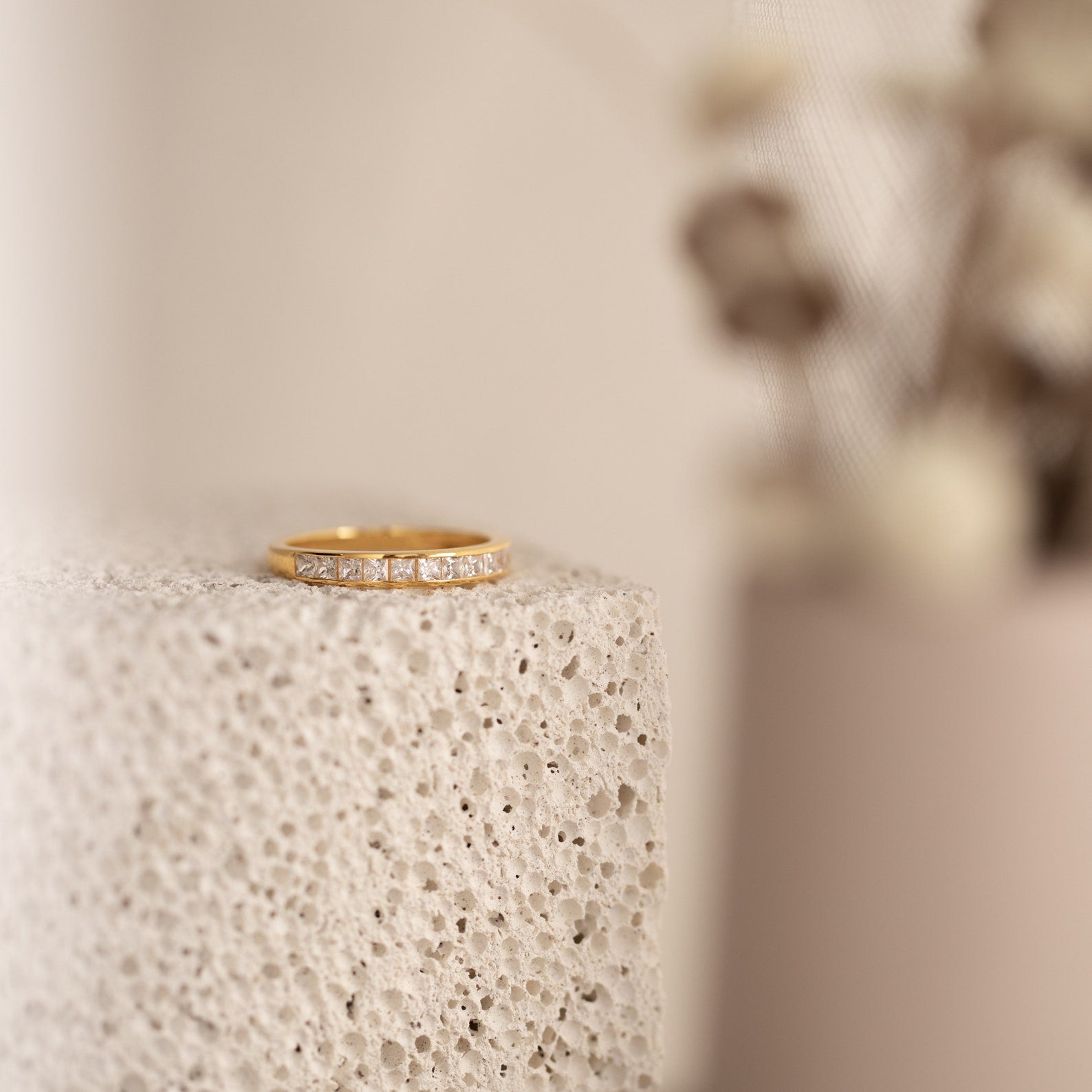 Evermore Diamond Band in 18K gold with pave-set diamonds on textured neutral background.