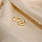 Baguette Ear Cuffs, shown with gold hoop earrings featuring rectangular crystals on champagne satin, add a modern and elegant touch to your look.
