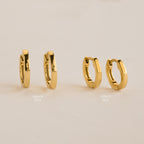 Two pairs of gold hoops, Editor IV 10mm and Editor III Huggies, are displayed on a beige background—ideal for fans of minimalist jewelry.