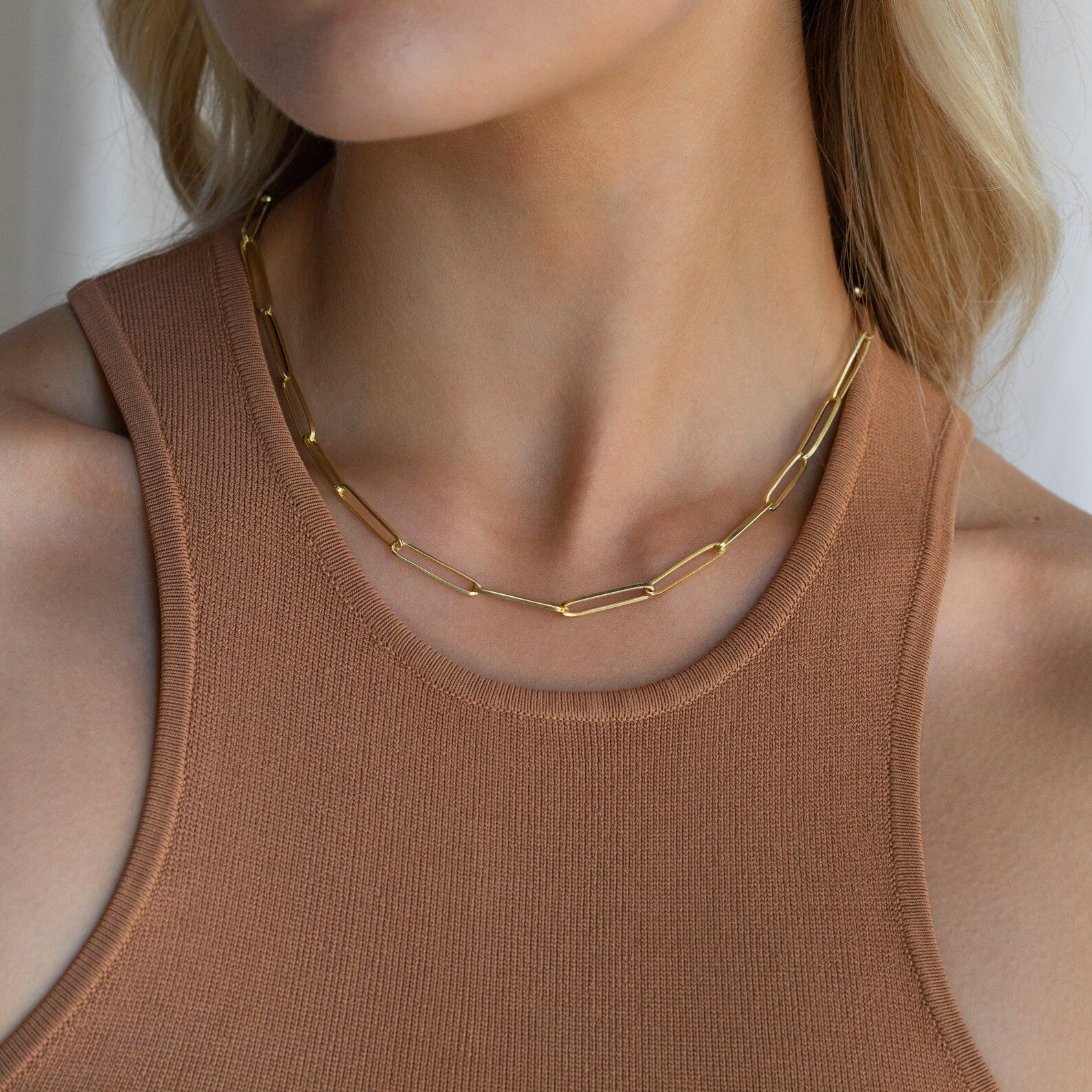 Woman wearing a sleeveless, ribbed brown top styled with the Custom Link Chain Necklace featuring bold, large links.