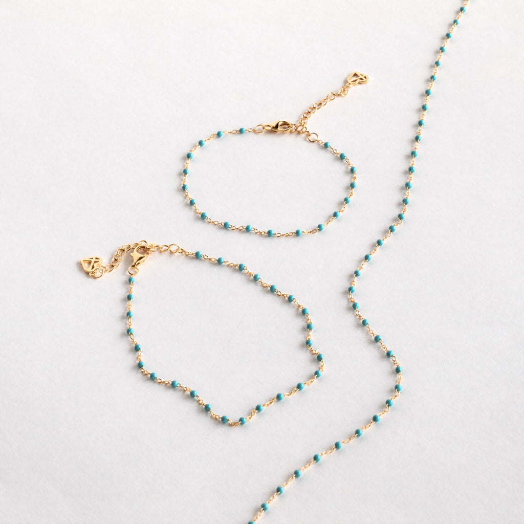 A Turquoise Station Necklace is displayed on a light grey surface.