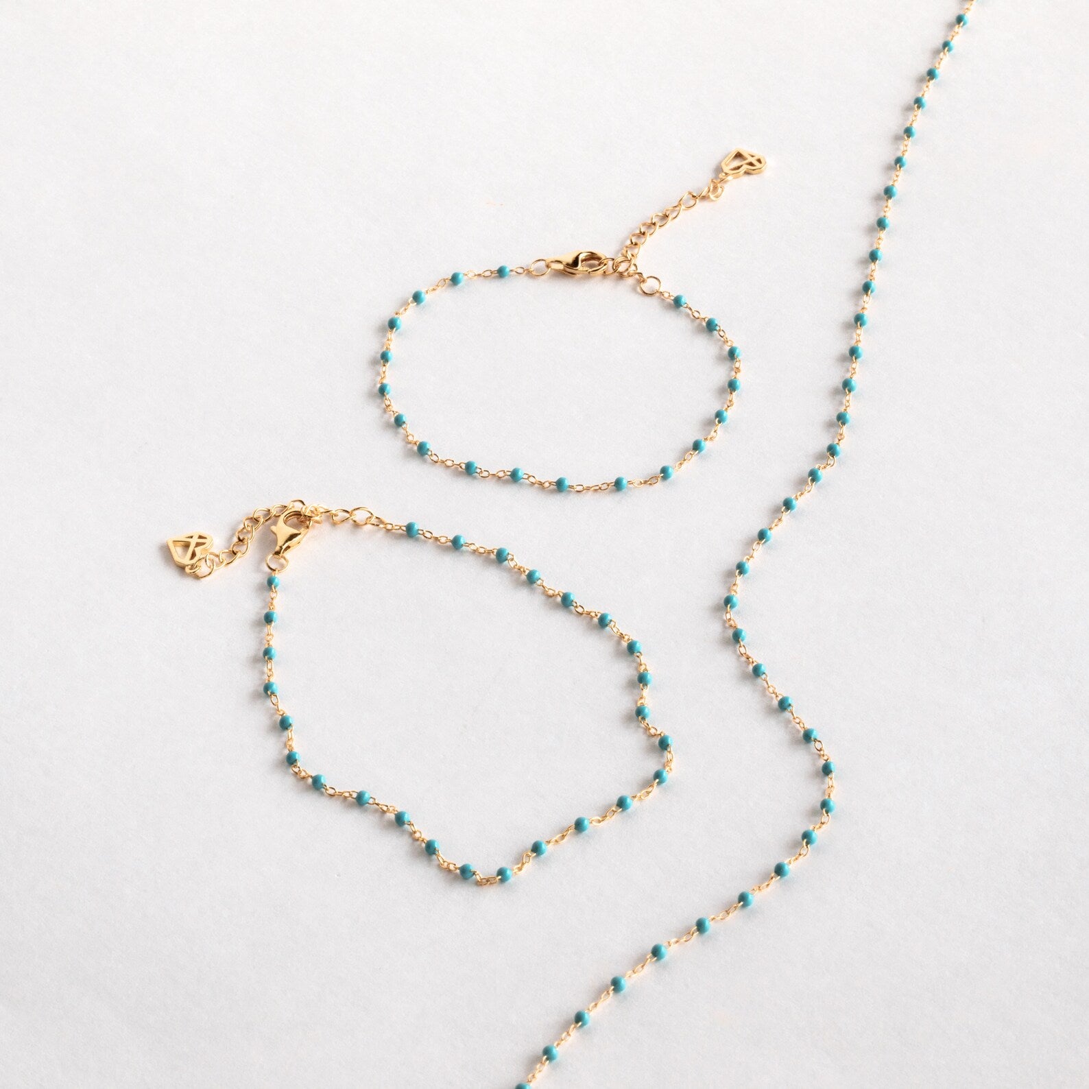 A Turquoise Station Necklace is displayed on a light grey surface.